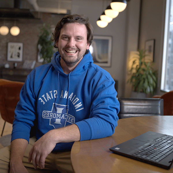 A man wearing Indiana State University gear smiling towards the camera.