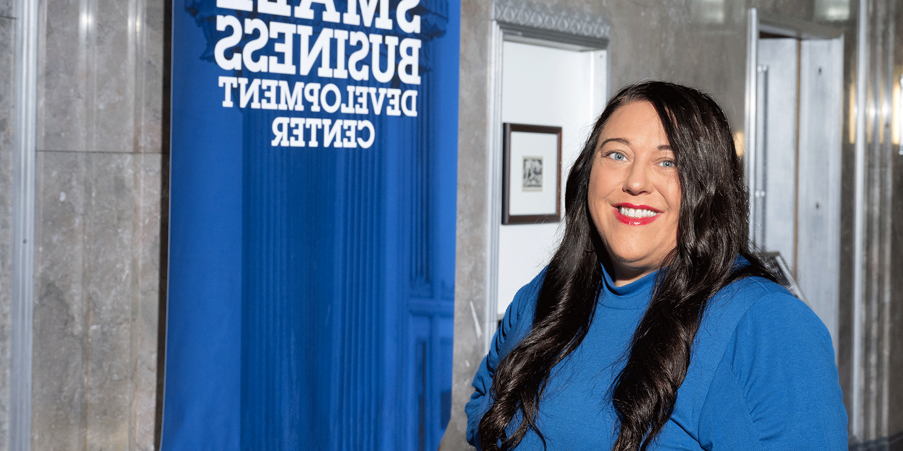 Courtney Richey-Chipol stands in front of the Small Business Development Center